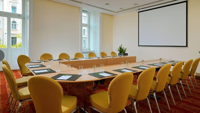 Meeting room with large table and yellow chairs at Courtyard by Marriott.