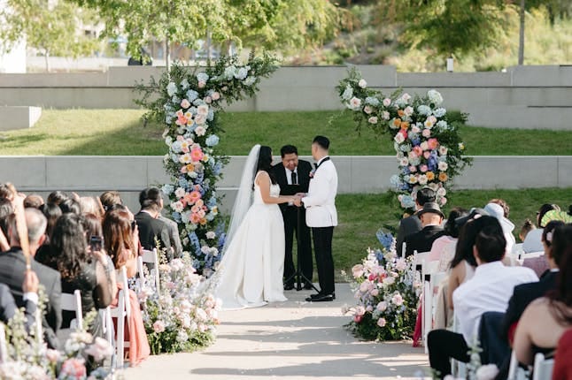 Outdoor wedding ceremony at Legacy Resort with elegant floral arch and guest seating.