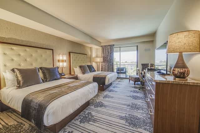 Legacy Conference Center hotel room with two queen beds, ideal for meetings and networking.