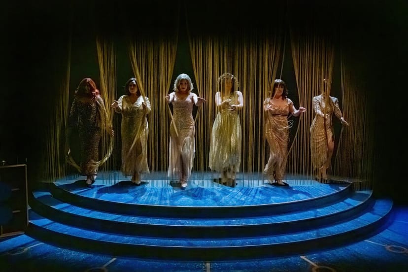 Elegant stage performance at Lamb's Players Theatre with dramatic lighting and ambiance.