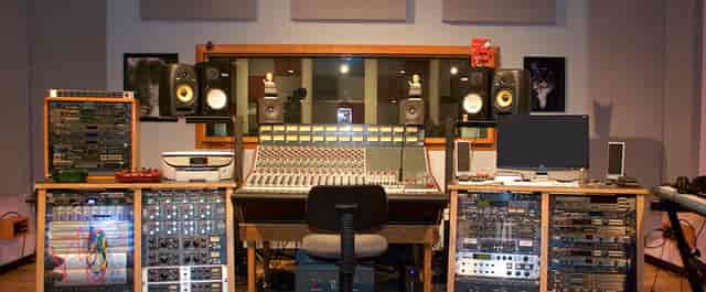 Professional recording studio with mixing console, ideal for music workshops and events.
