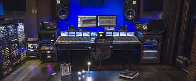 Modern recording studio with sleek mixing console, ideal for music workshops and events.