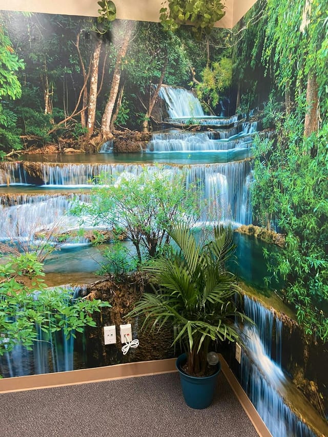 Serene waterfall scene in Suite B, perfect for wellness retreats and nature events.