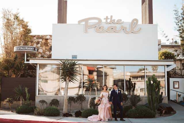Charming wedding venue at The Pearl Hotel with stylish exterior and greenery.