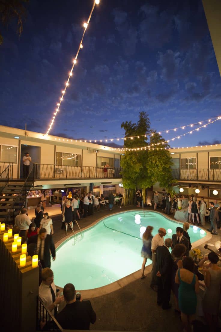 Outdoor wedding venue at The Pearl Hotel with pool and string lights, perfect for receptions.