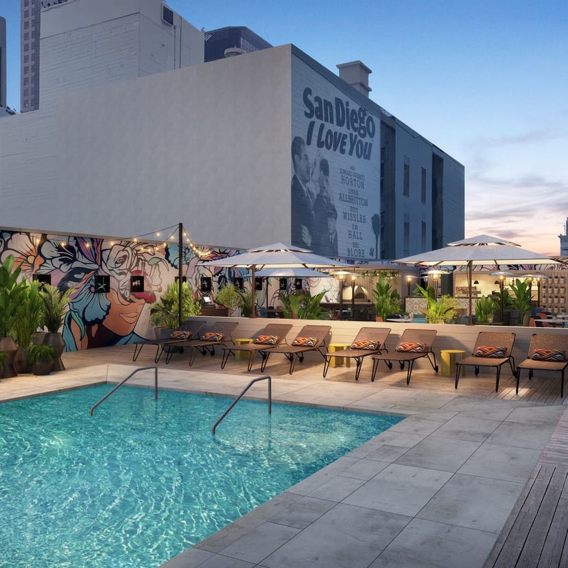 Vibrant outdoor event space at Kimpton Alma Hotel with stylish pool and mural.