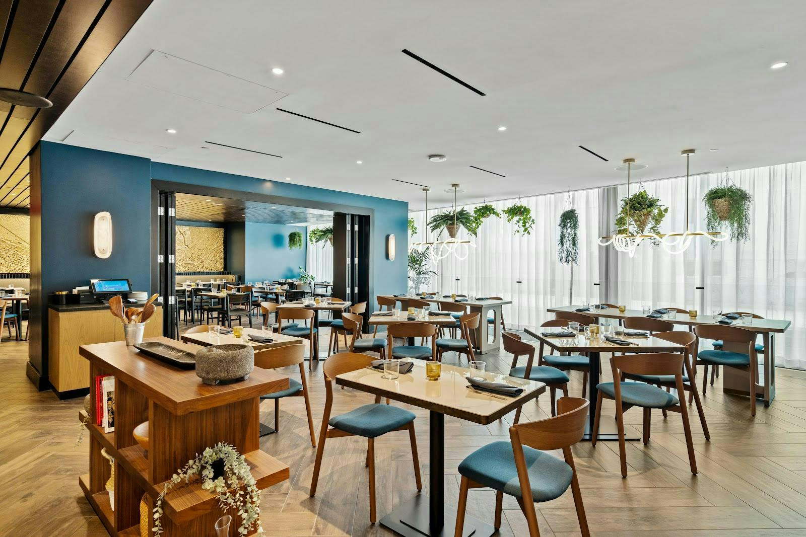 Carmen in modern dining space at Kimpton Alma Hotel, perfect for networking events.