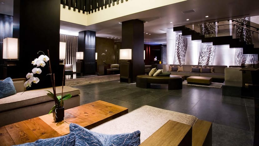 Modern lobby at Kimpton Alma Hotel with orchid centerpiece, ideal for events and networking.