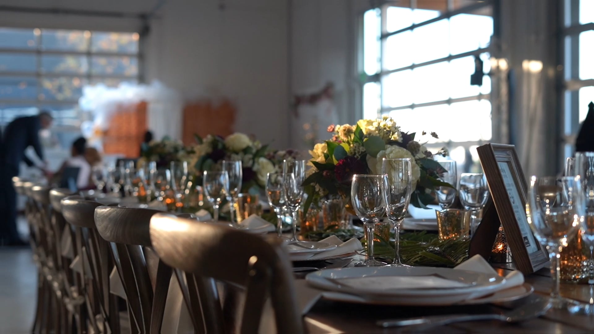 Elegant indoor venue with long dining table, floral centerpieces for events in Salt Drift Pointe.