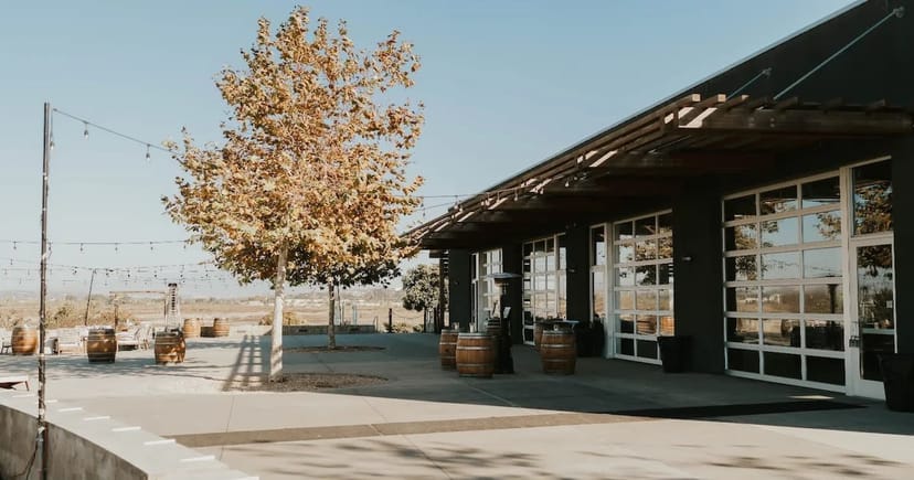 Charming outdoor event venue with rustic barrels and scenic views at Salt Drift Pointe.