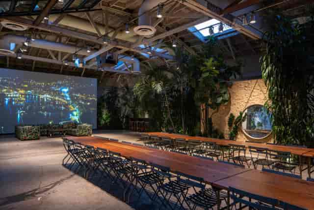 Versatile event space in Millwick with long tables and greenery for meetings and gatherings.