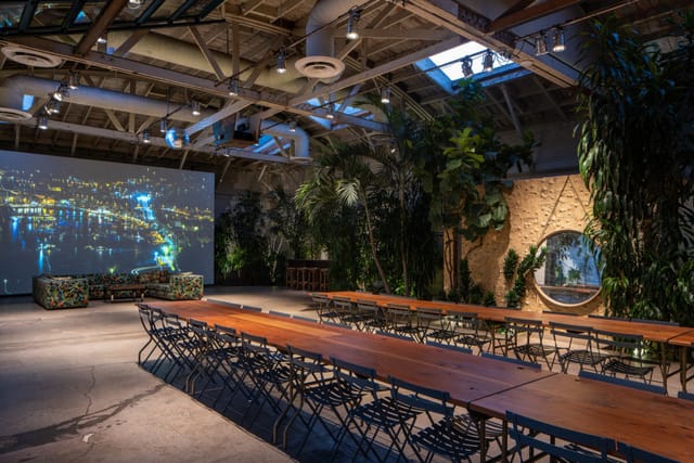 Versatile event space in Millwick with long tables and greenery for meetings and gatherings.