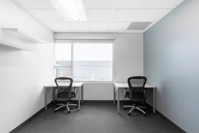 Minimalist office meeting space with ergonomic chairs, ideal for team brainstorming sessions.