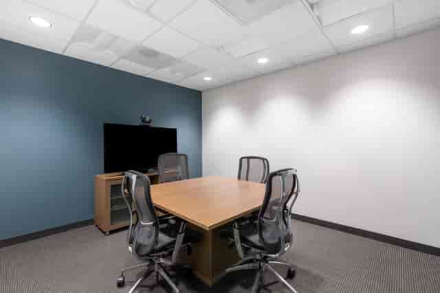 Modern minimalist meeting room with ergonomic chairs for collaborative discussions.