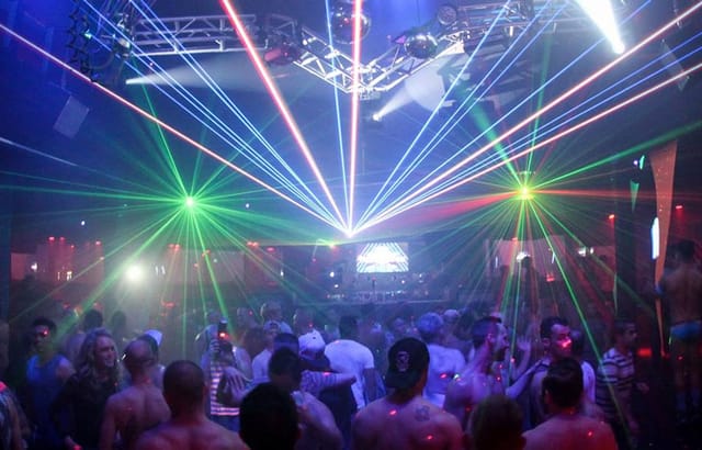 Vibrant lounge area with dynamic laser lights at Spin Nightclub for nightlife events.