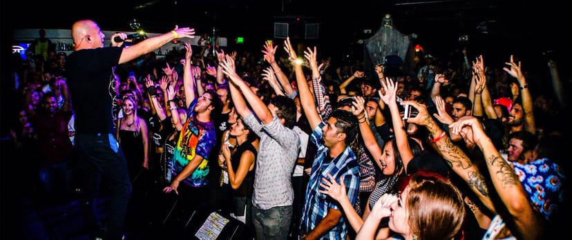 Vibrant lounge area at Spin Nightclub during a live event with engaged crowd.