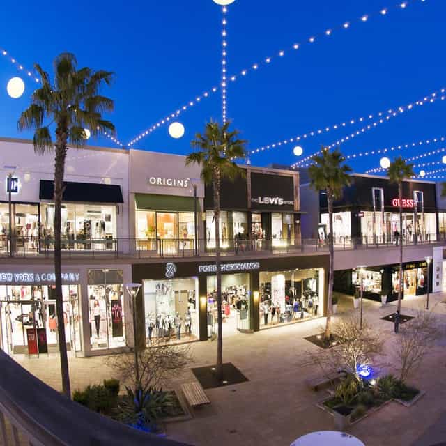Vibrant outdoor shopping area with string lights for events at Del Amo Fashion Center.