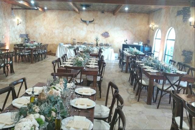 Grand Ballroom at Encore Event Center, rustic wooden tables, ideal for weddings and upscale events.