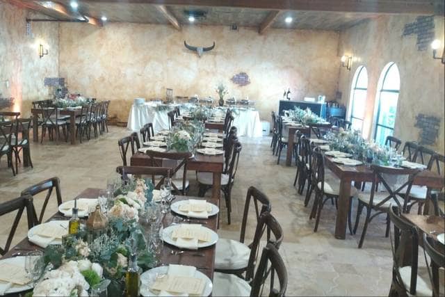 Grand Ballroom at Encore Event Center, rustic wooden tables, ideal for weddings and upscale events.