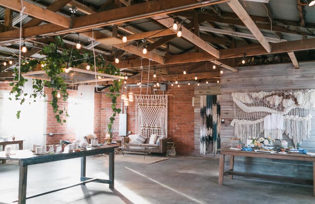 Rustic event space with wooden beams, ideal for intimate gatherings and workshops.