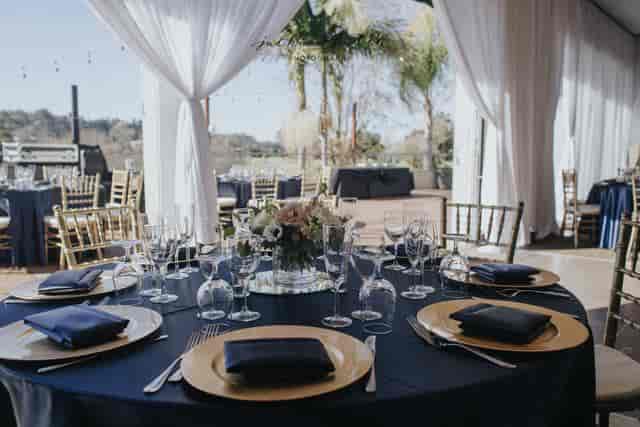 Elegant banquet hall with navy tables and gold accents for sophisticated events.
