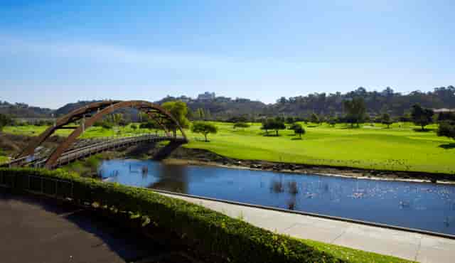 Clubhouse at Riverwalk Golf Club with lush greenery, ideal for outdoor events and retreats.