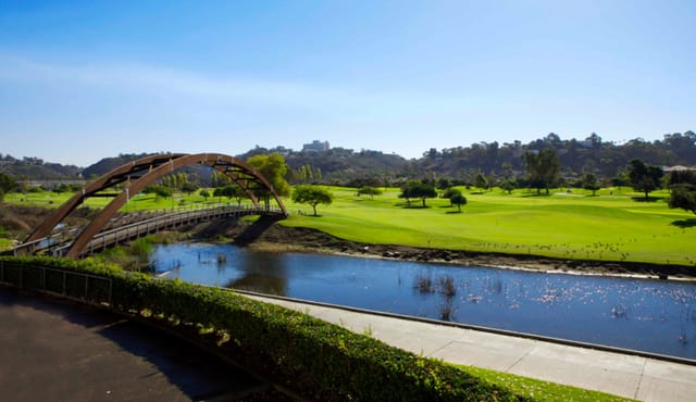 Clubhouse at Riverwalk Golf Club with lush greenery, ideal for outdoor events and retreats.