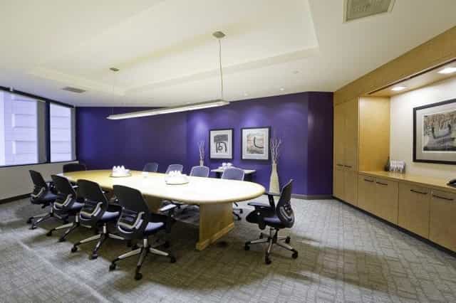 Modern conference room in Emerald Plaza with oval table, ideal for meetings and brainstorming.