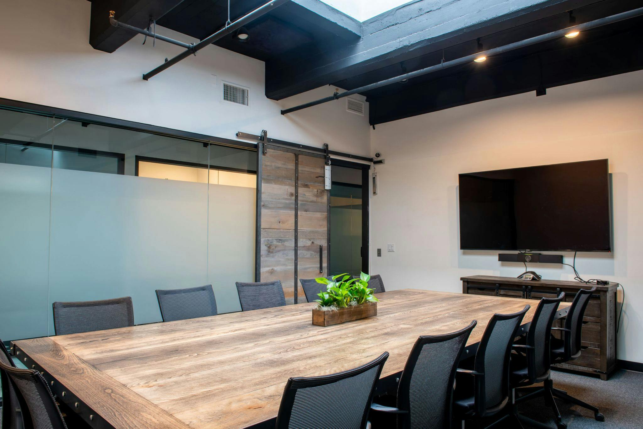 Modern meeting room with wooden table, ideal for collaboration and presentations in Pasadena.