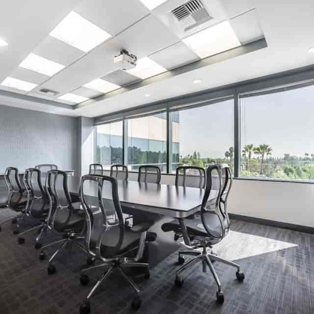 Modern conference room with large table and ergonomic chairs in Century Square, Pasadena.