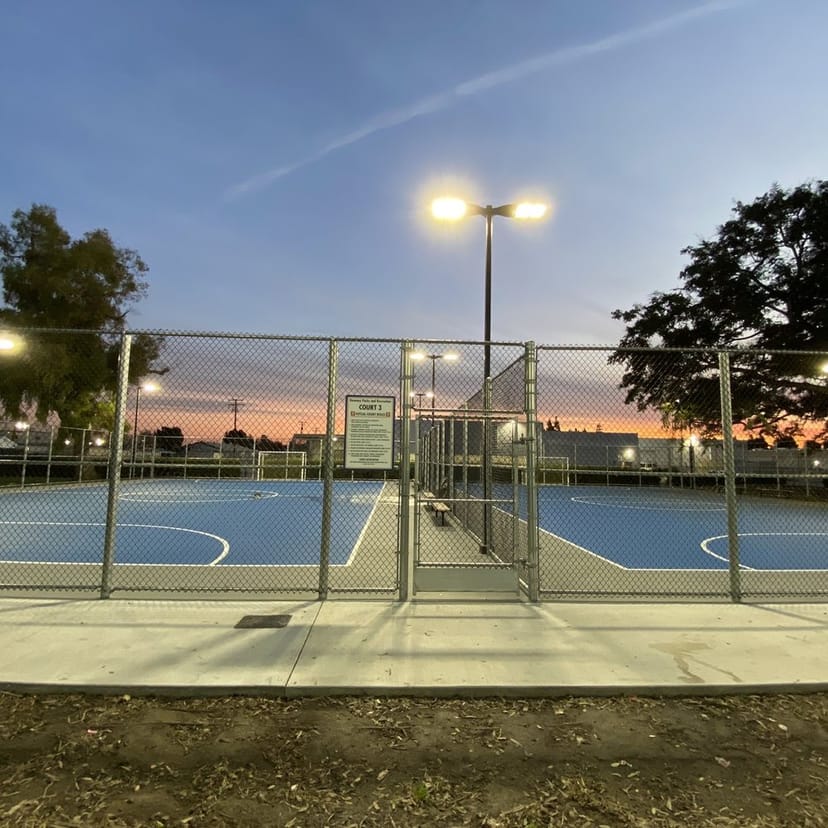 Illuminated basketball court at John S. Simms Park, perfect for tournaments and gatherings.
