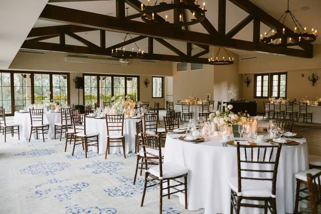 Elegant event space with round tables and floral centerpieces at Chevy Chase Country Club.