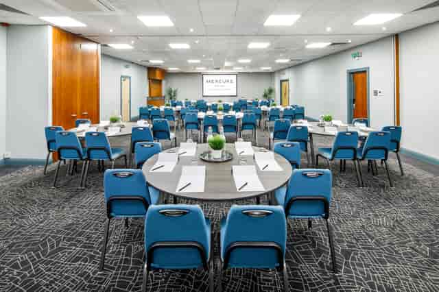 Hallard Suite at Mercure Birmingham: inviting meeting space with round tables for workshops.