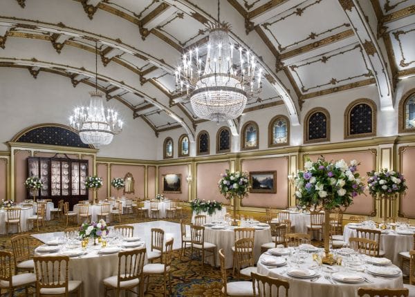 Elegant banquet hall with chandeliers, perfect for weddings and corporate events.