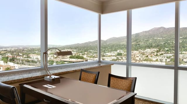 Modern meeting room at Embassy Suites Glendale with mountain view, perfect for events.