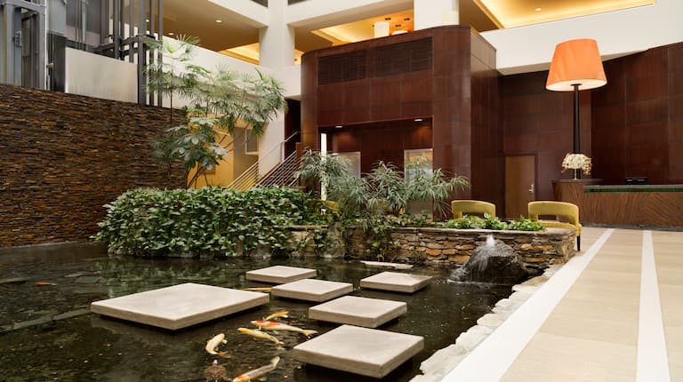 Embassy Suites Glendale lobby with serene water feature, ideal for elegant events.