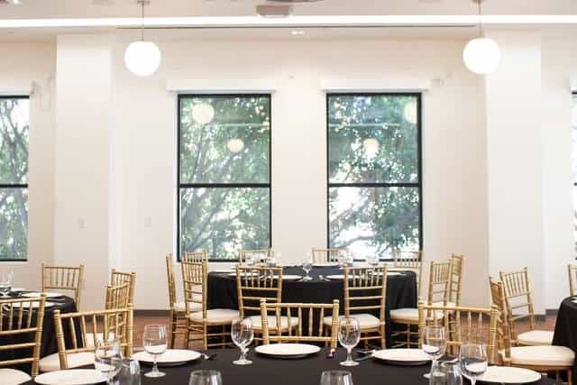 Elegant event space with black linens and gold chairs at Pasadena Hotel & Pool.