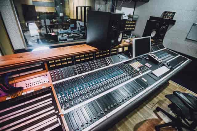 Professional audio mixing console in rehearsal space for high-quality sound production.