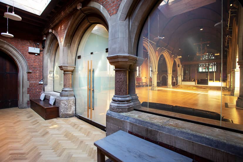Main Space in St Dionis Church with arched windows, perfect for events and gatherings.