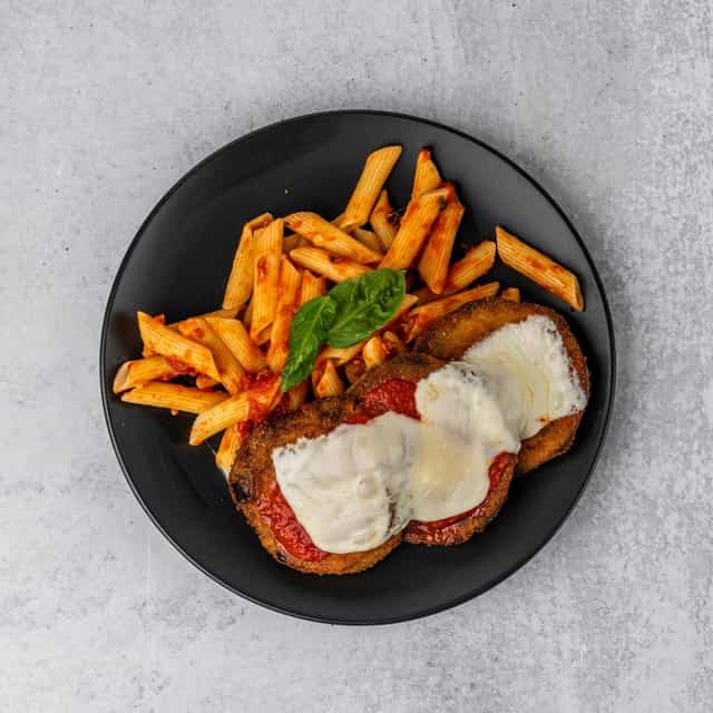 Chicken parmesan with penne pasta at Ferraro's On The Hill, perfect for catering events.