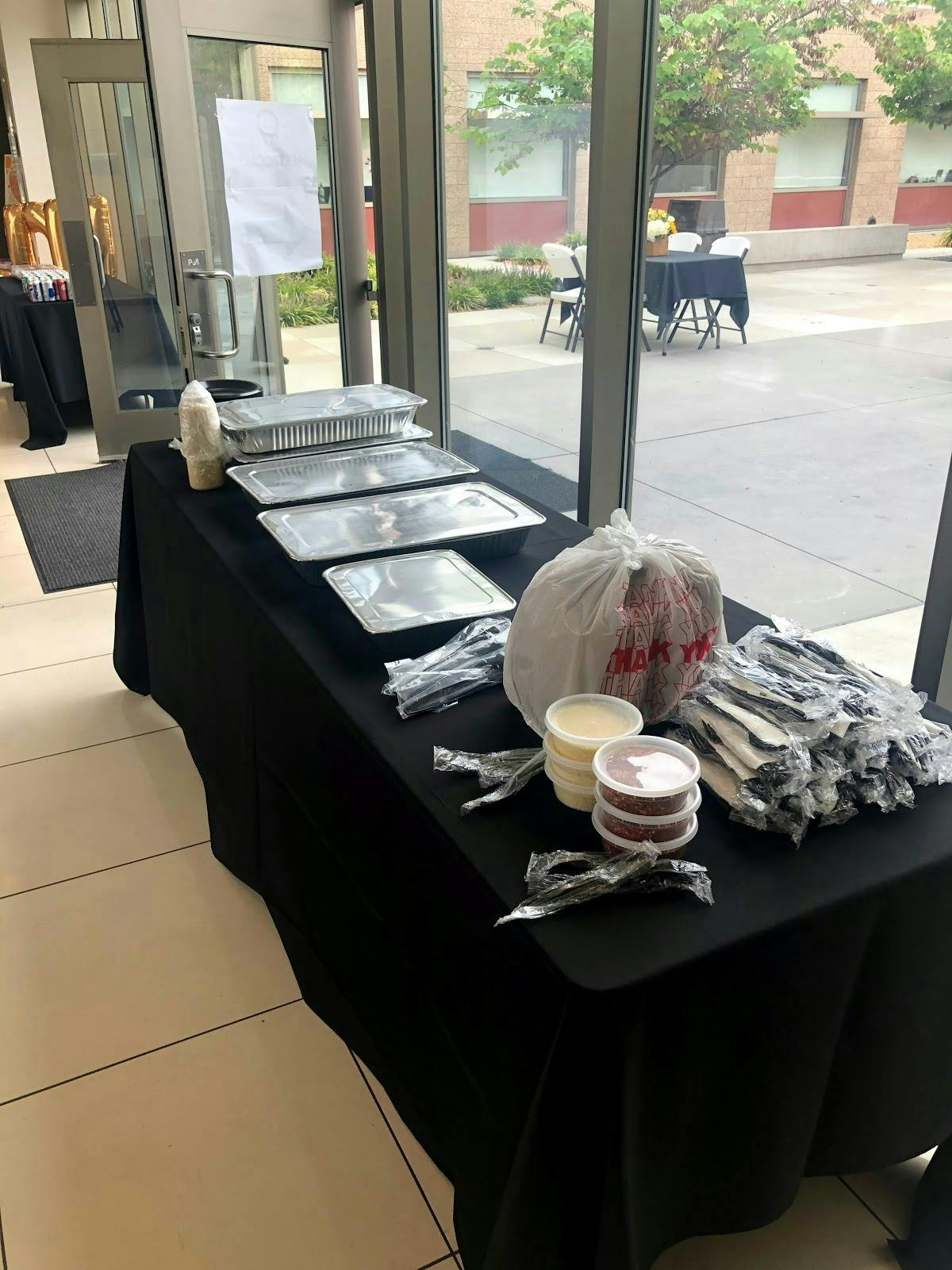 Catering setup at Ferraro's on the Hill with organized food containers and utensils.