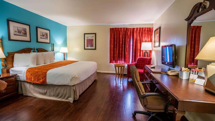 "Spacious hotel suite with king bed, ideal for business meetings and events in Buena Park."