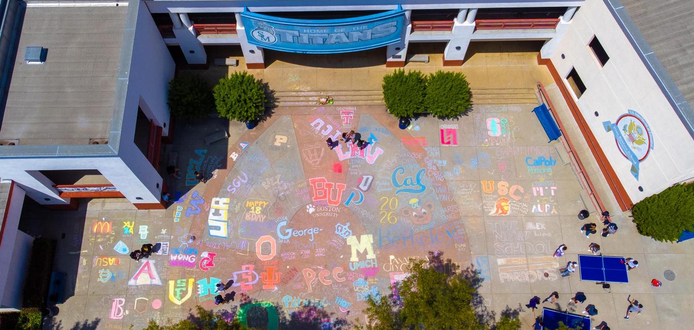 Colorful chalk art at San Marino High School library for college fair event.