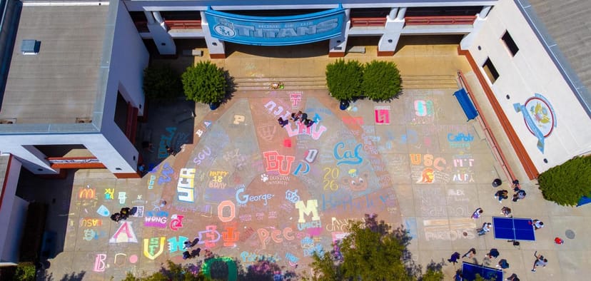 Colorful chalk art at San Marino High School library for college fair event.