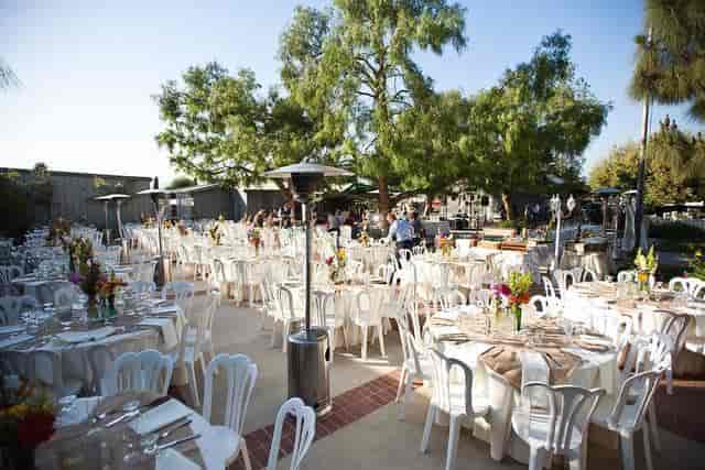 Elegant barn venue with floral centerpieces for weddings and corporate events.