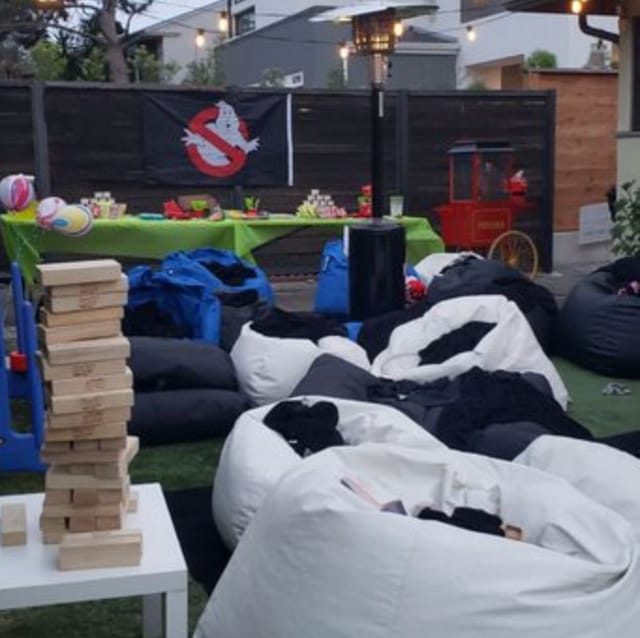 Baby shower event space with bean bags, Jenga tower, and playful decor for fun gatherings.