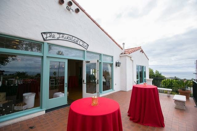Charming balcony venue with red tablecloths, perfect for receptions and gatherings.