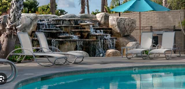 Serene poolside setting with waterfall, perfect for events and networking at The Point.