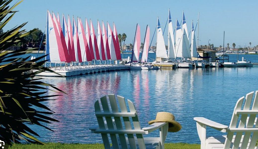 Sunset Deck at The Point: scenic waterfront venue for outdoor events with vibrant sailboats.
