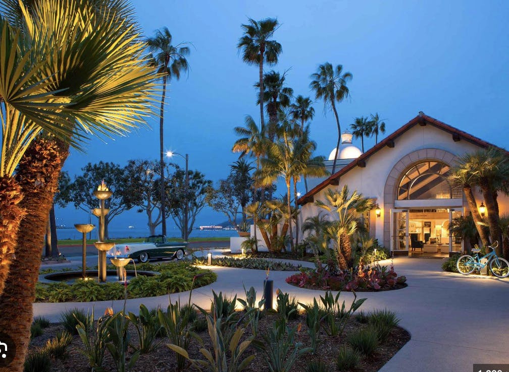 Sunset Pavilion North: elegant outdoor venue with palm trees for events by the water.